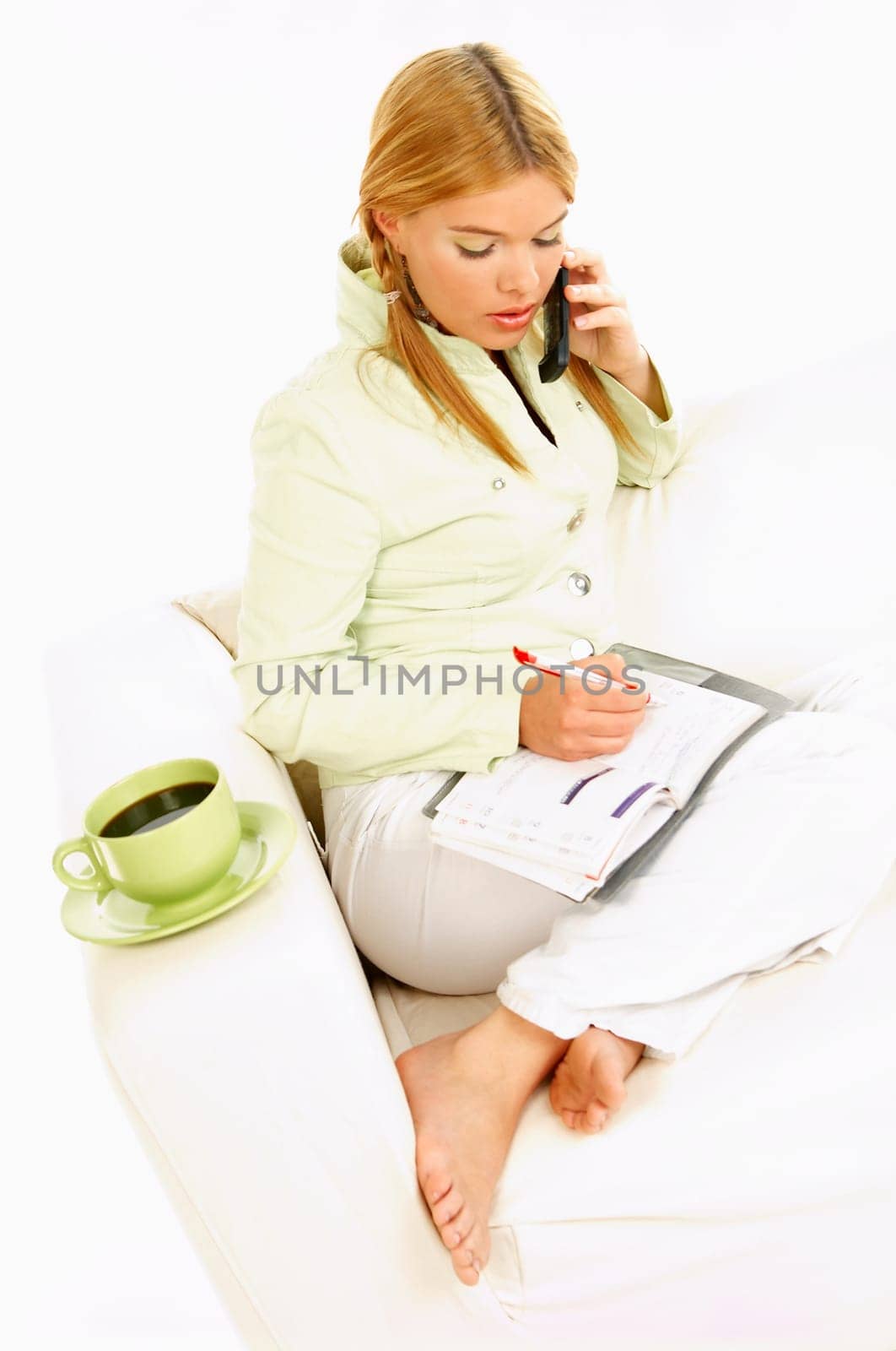 Portrait of attractive beautiful young woman with green cup of black coffee cell phone and notebook
