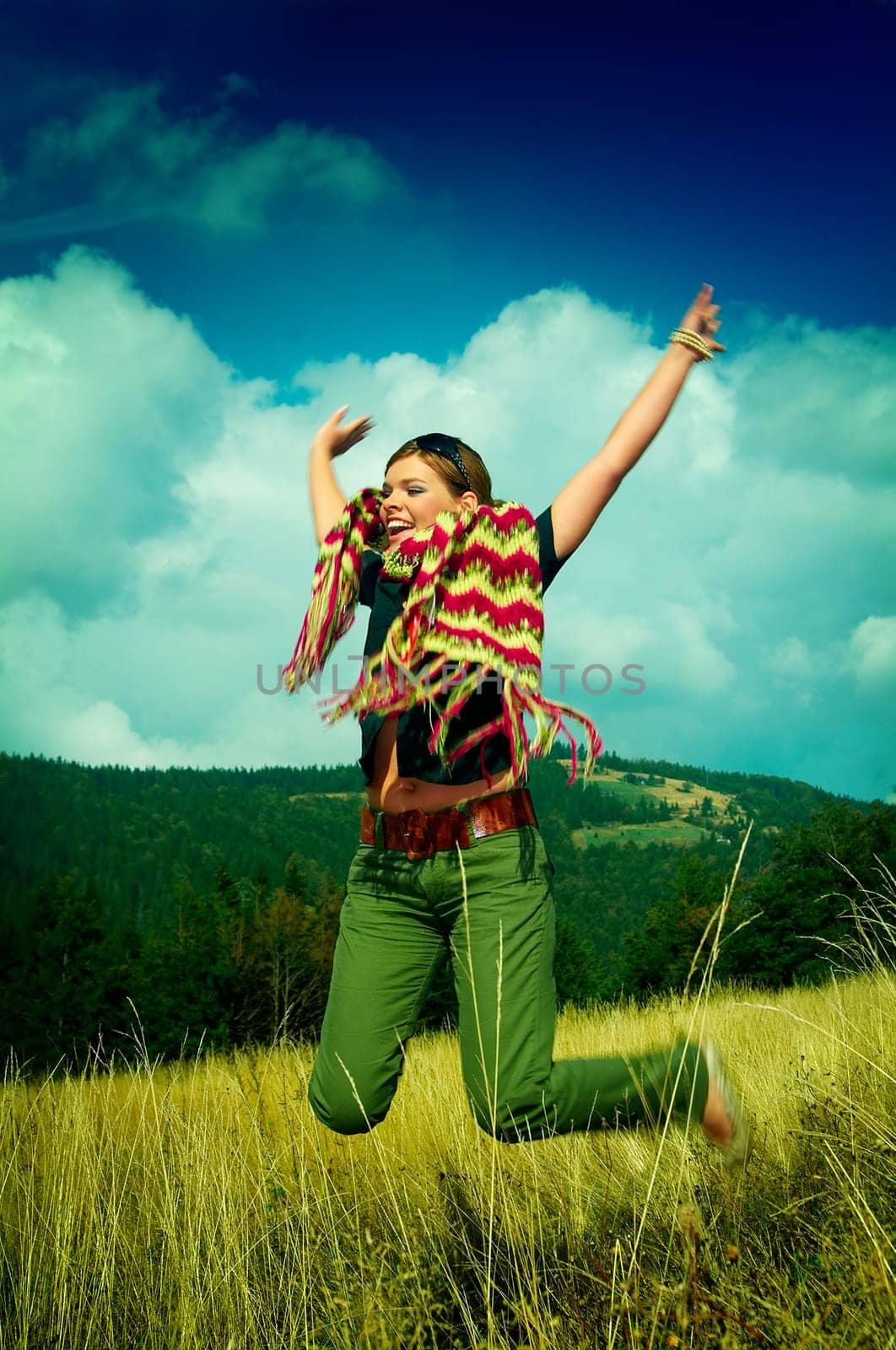 Young business woman relaxing on mountain meadow