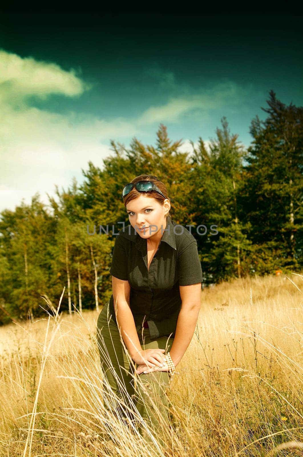 Young business woman relaxing on mountain meadow