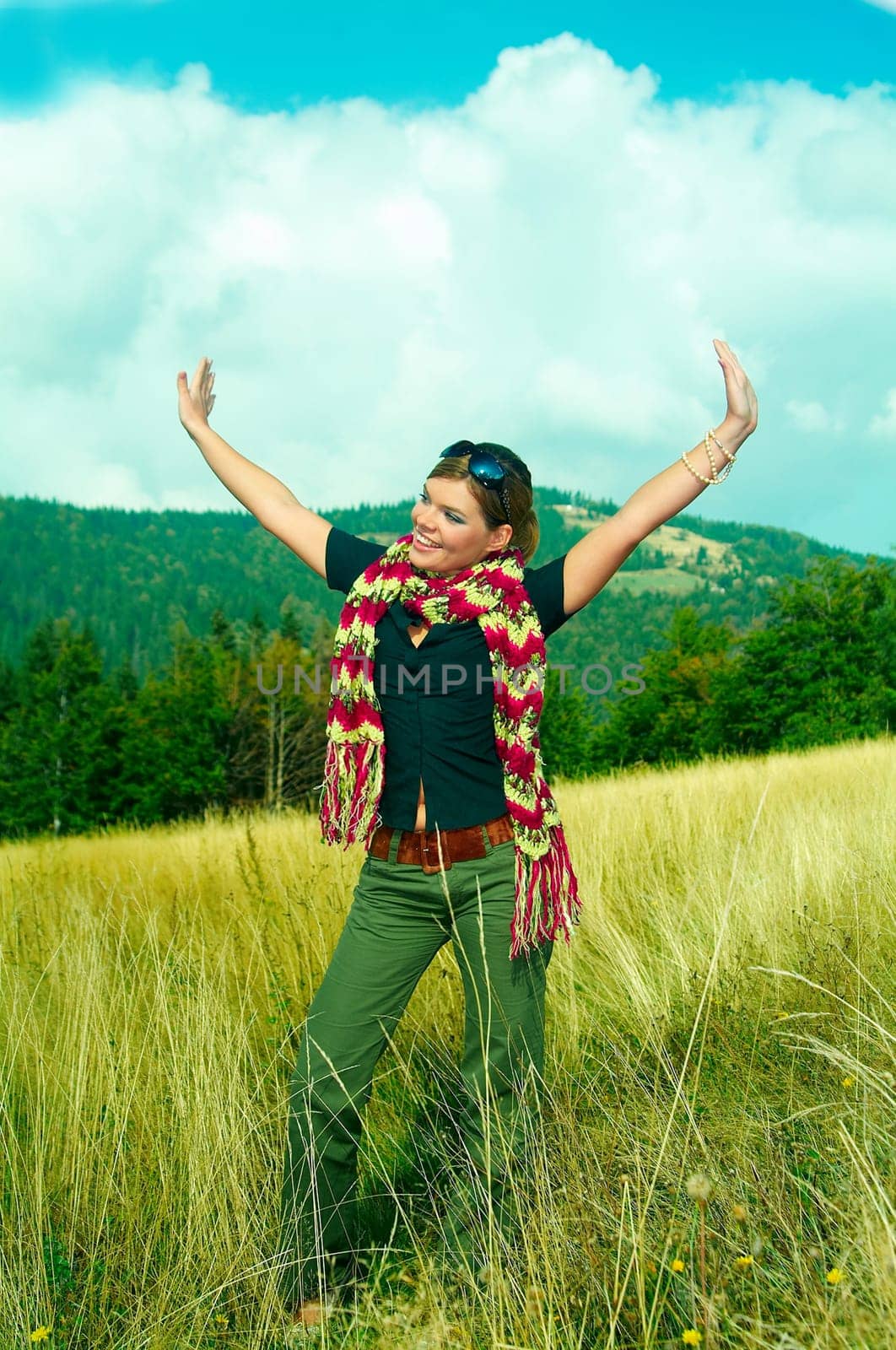 Young business woman relaxing on mountain meadow