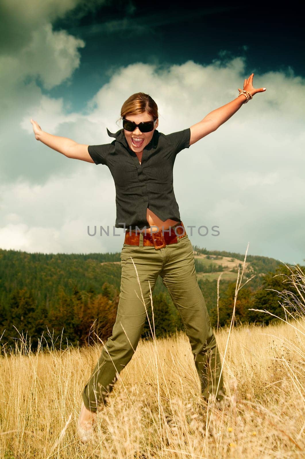 Young business woman relaxing on mountain meadow