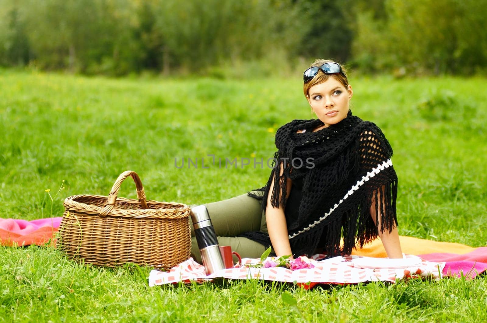 Young business woman during picnic on green meadows outdoors