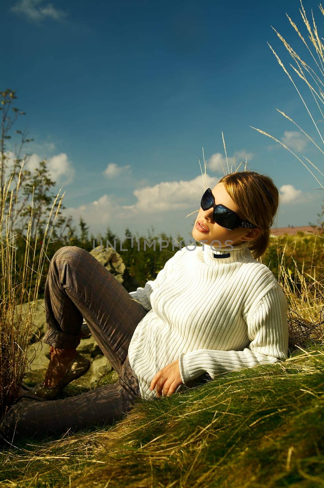 Young beautiful model posing in mountain outdoor scenery