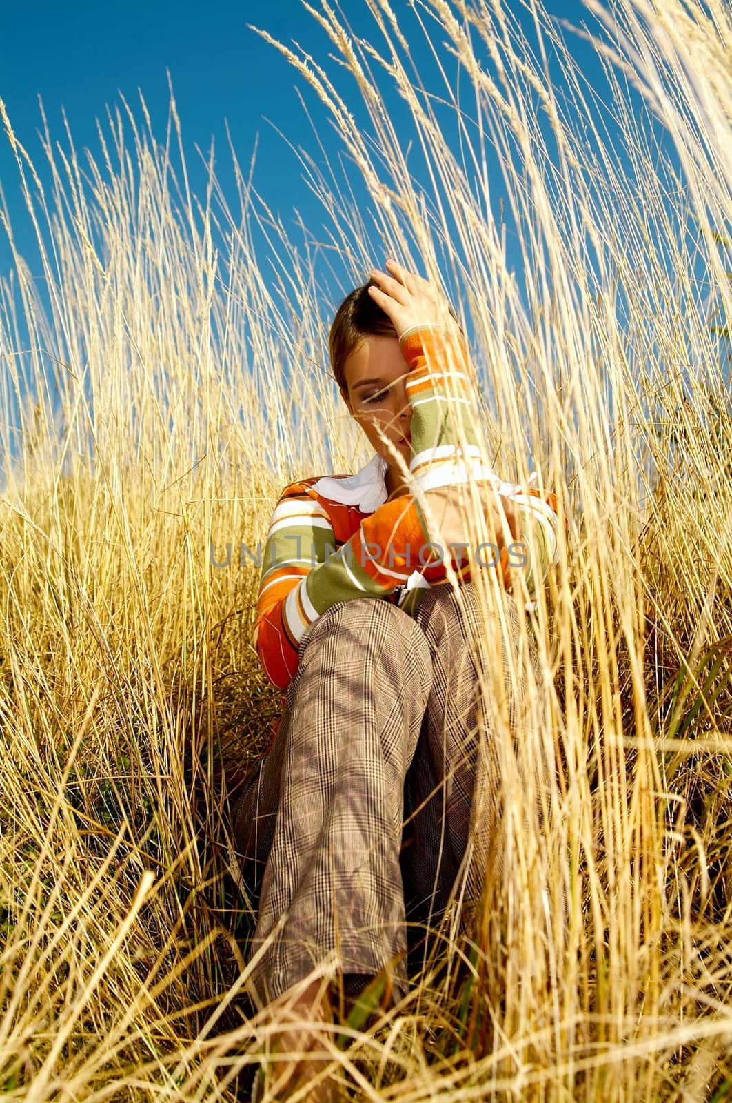 Young business woman relaxing on golden meadow