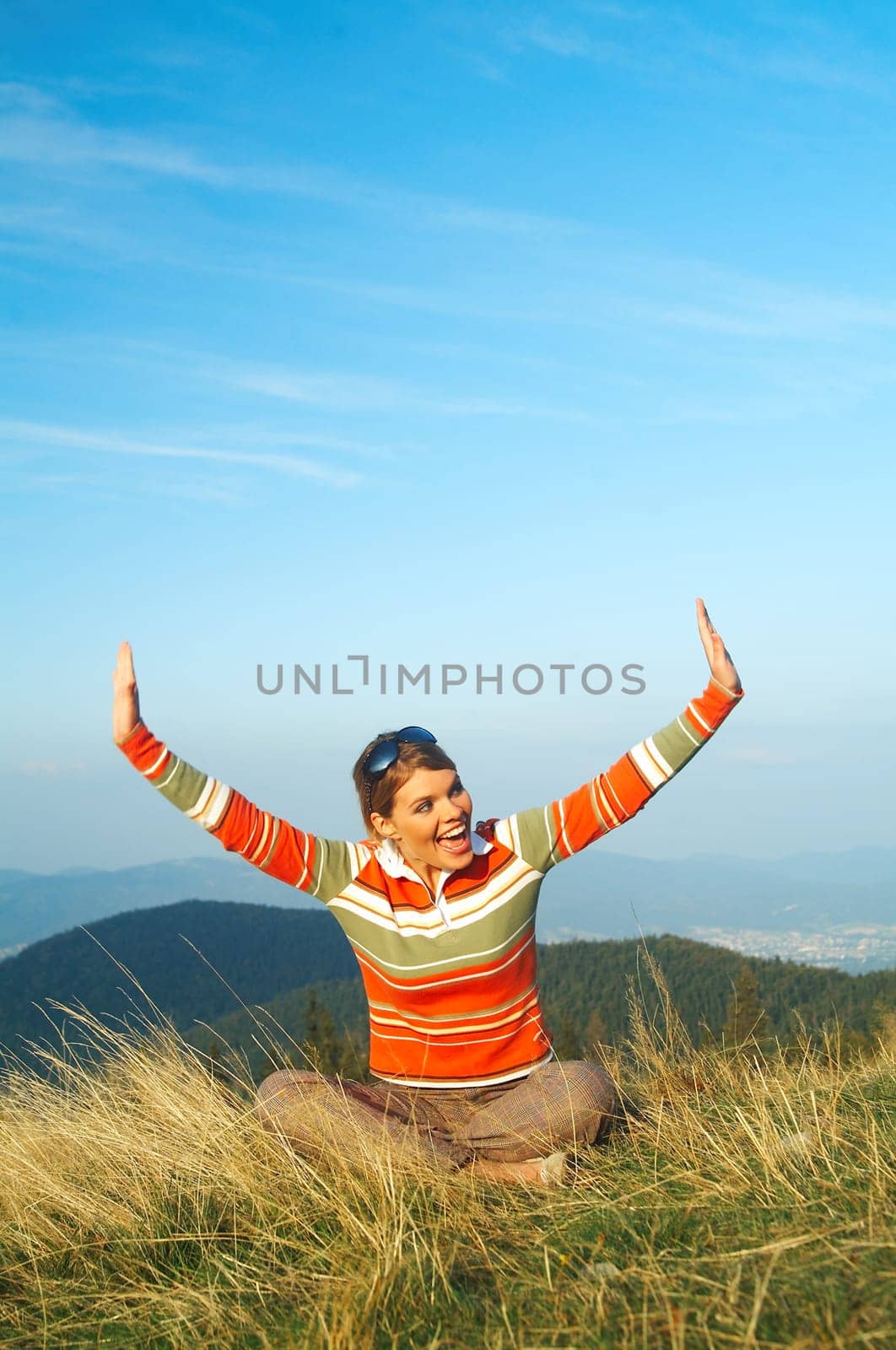 Young beautiful woman relaxing on meadow at mouintain outdoors