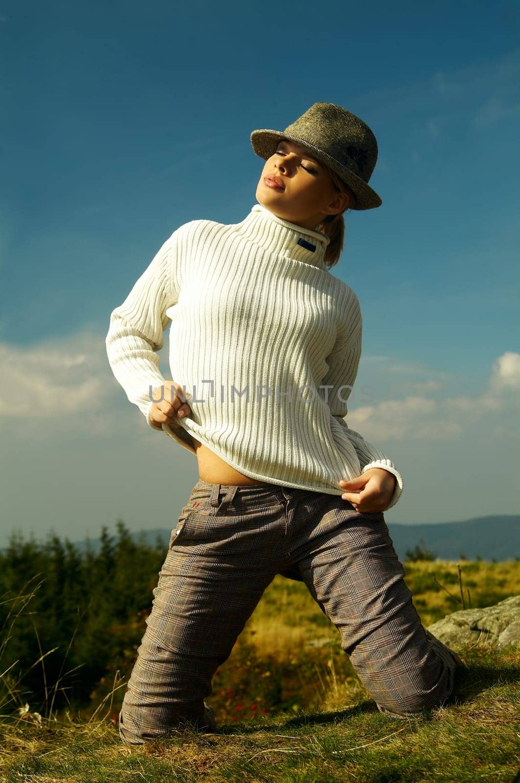 Young beautiful model posing in mountain outdoor scenery