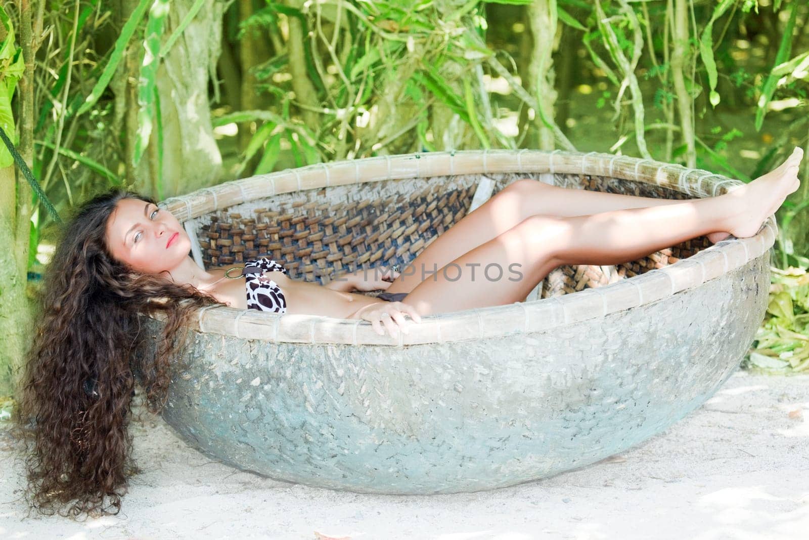Young beautiful woman in the fisherman boat