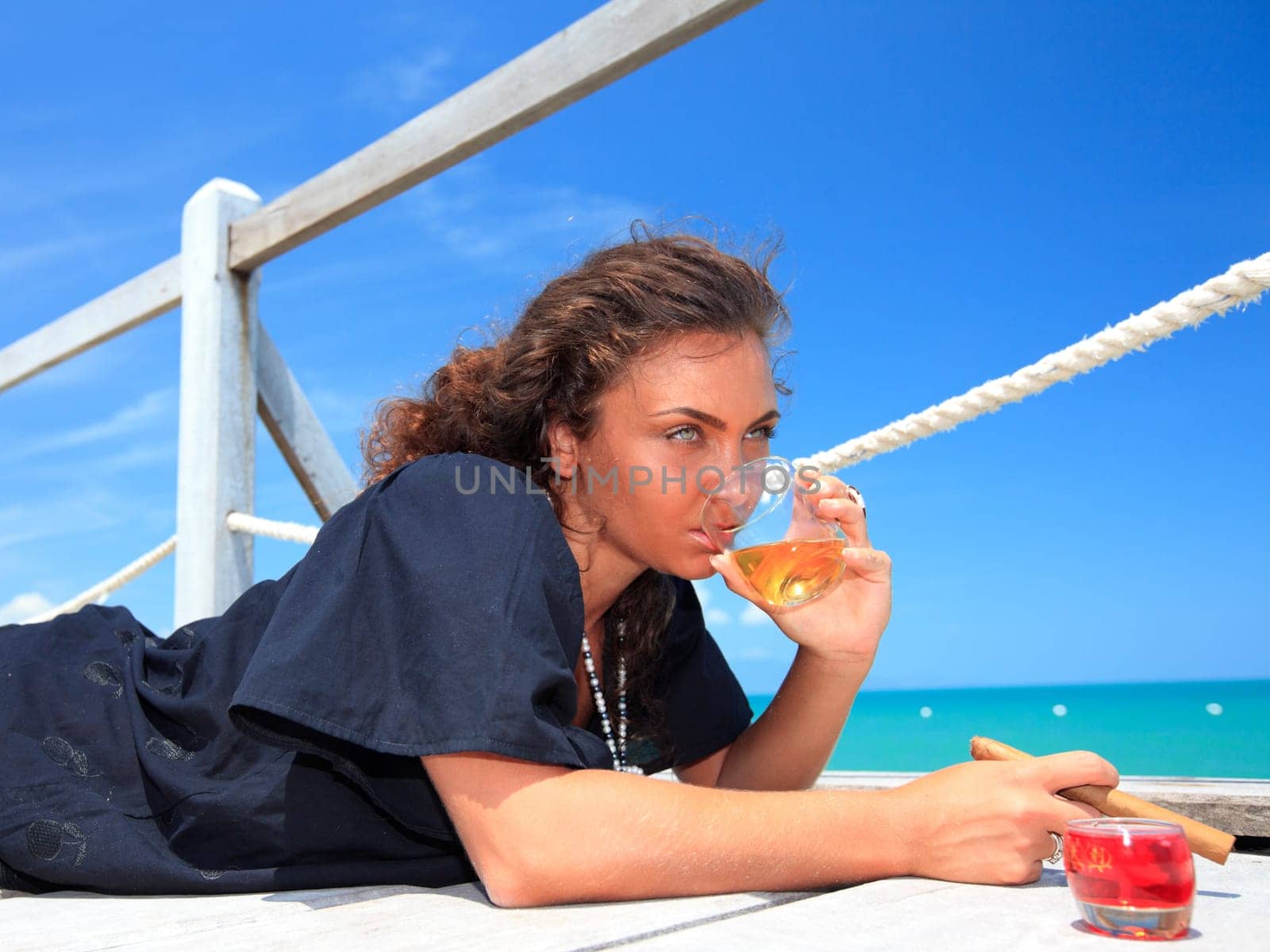 Young woman with cigar and a glass of whiskey