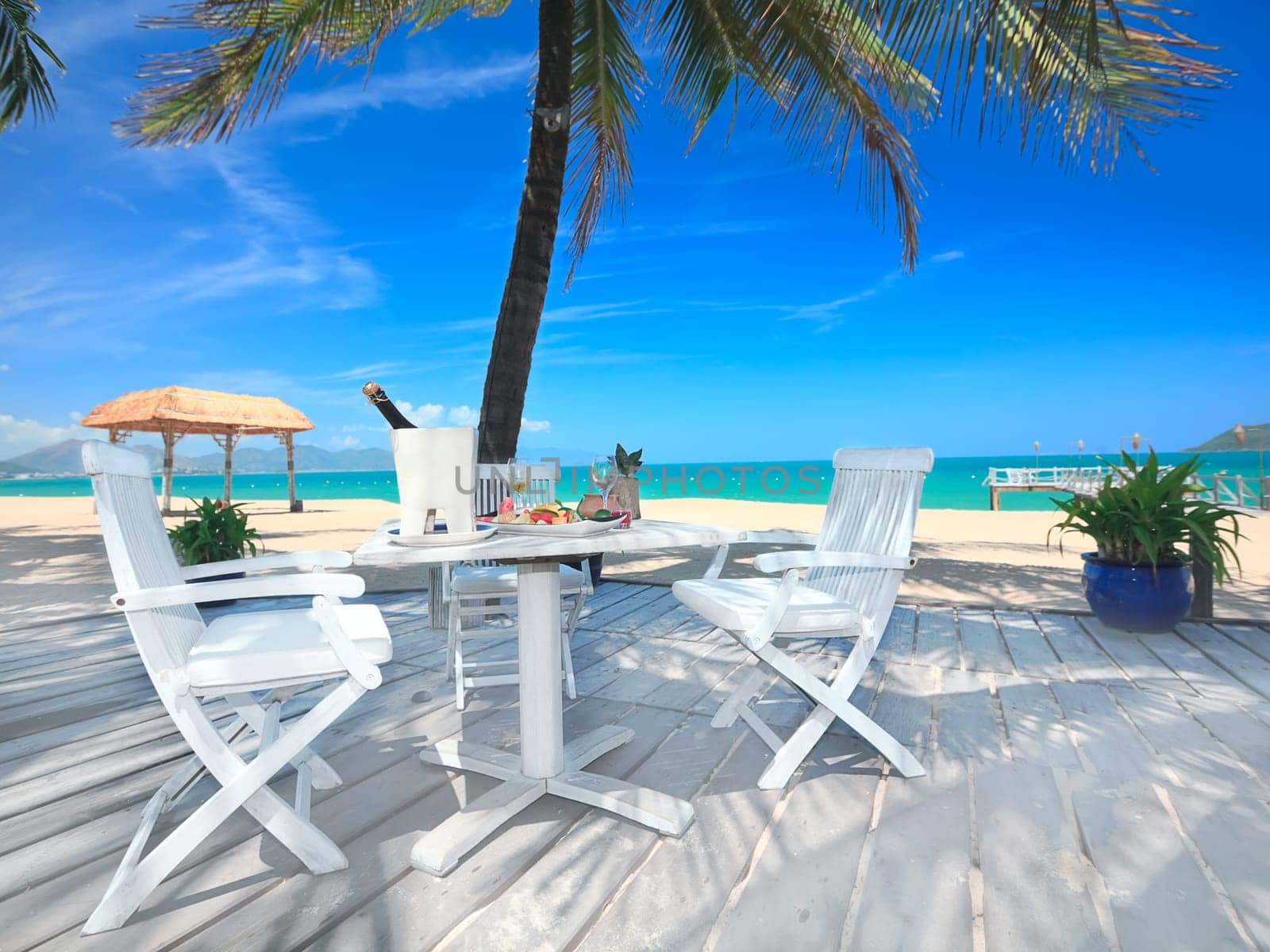 Dining table on the beach close to the ocean