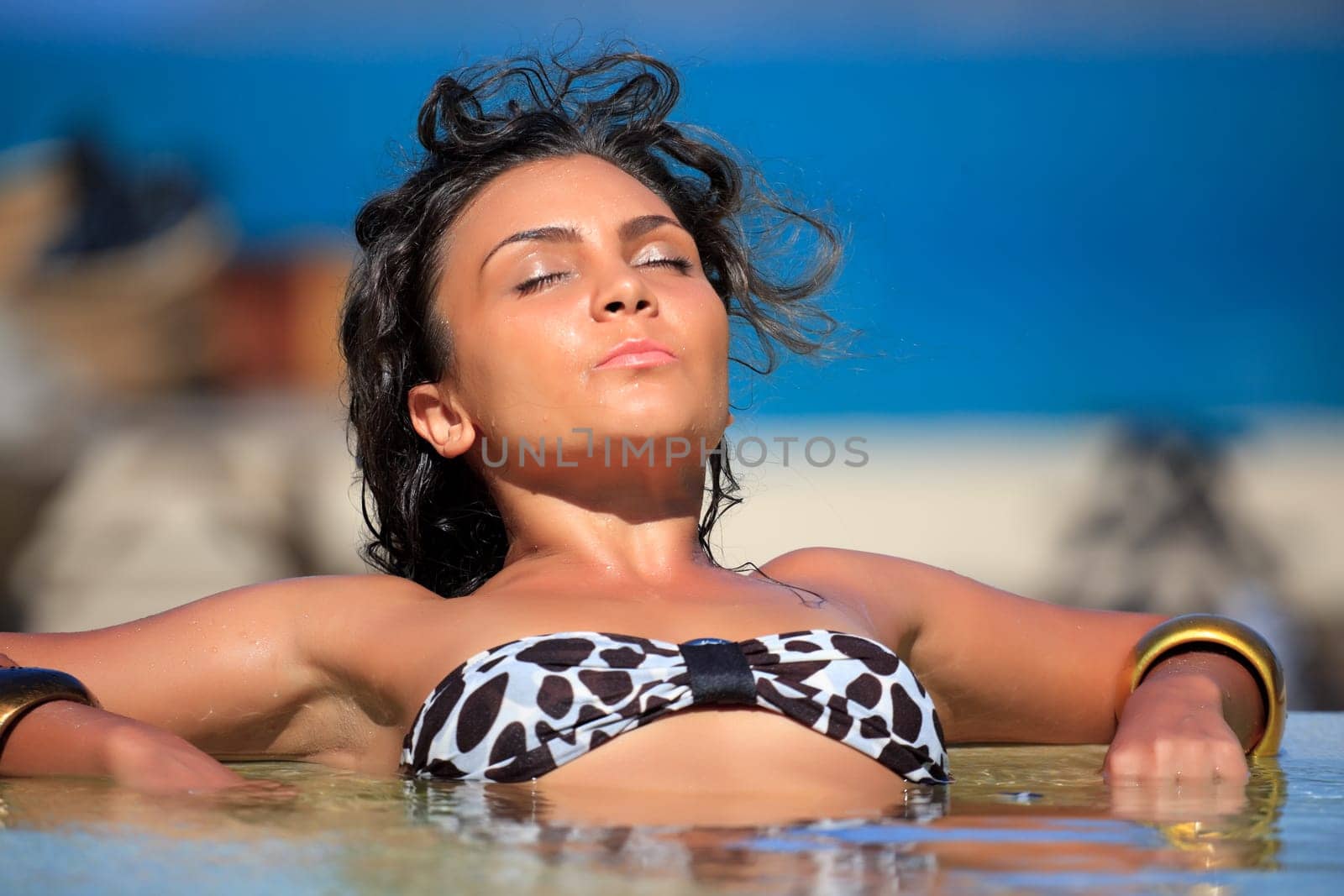 Young woman is relaxing in swimming pool