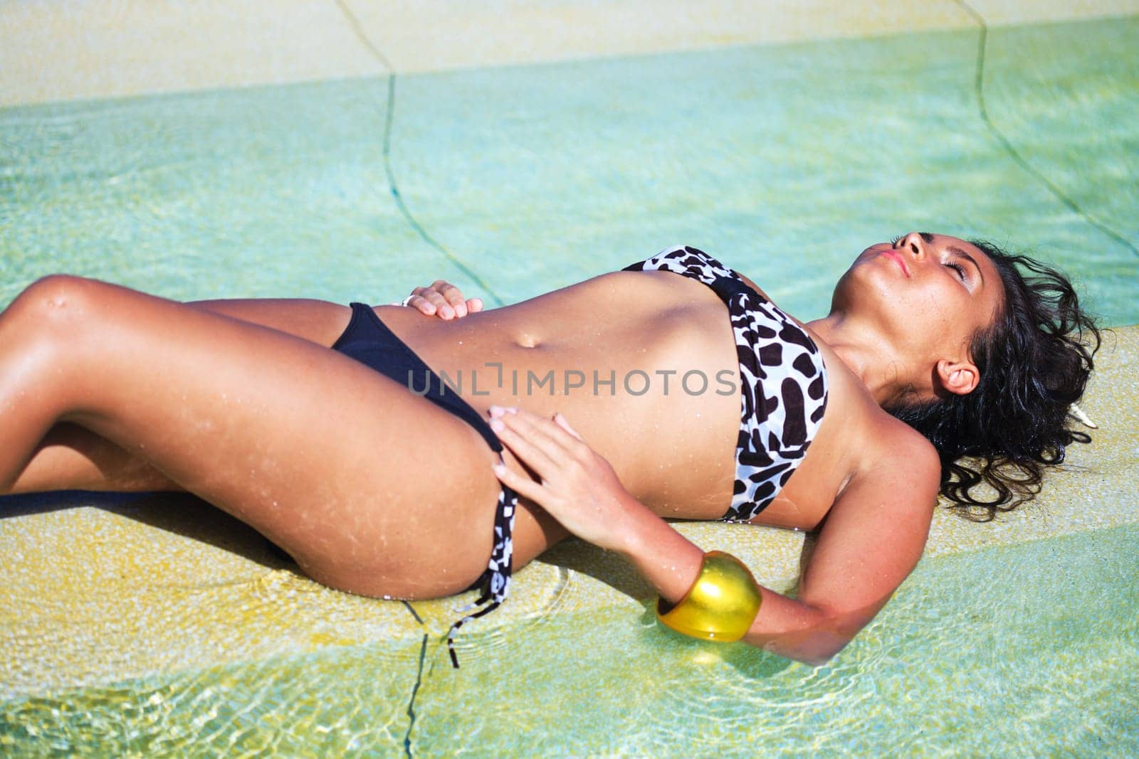 Young beautiful woman relaxing in swimming pool