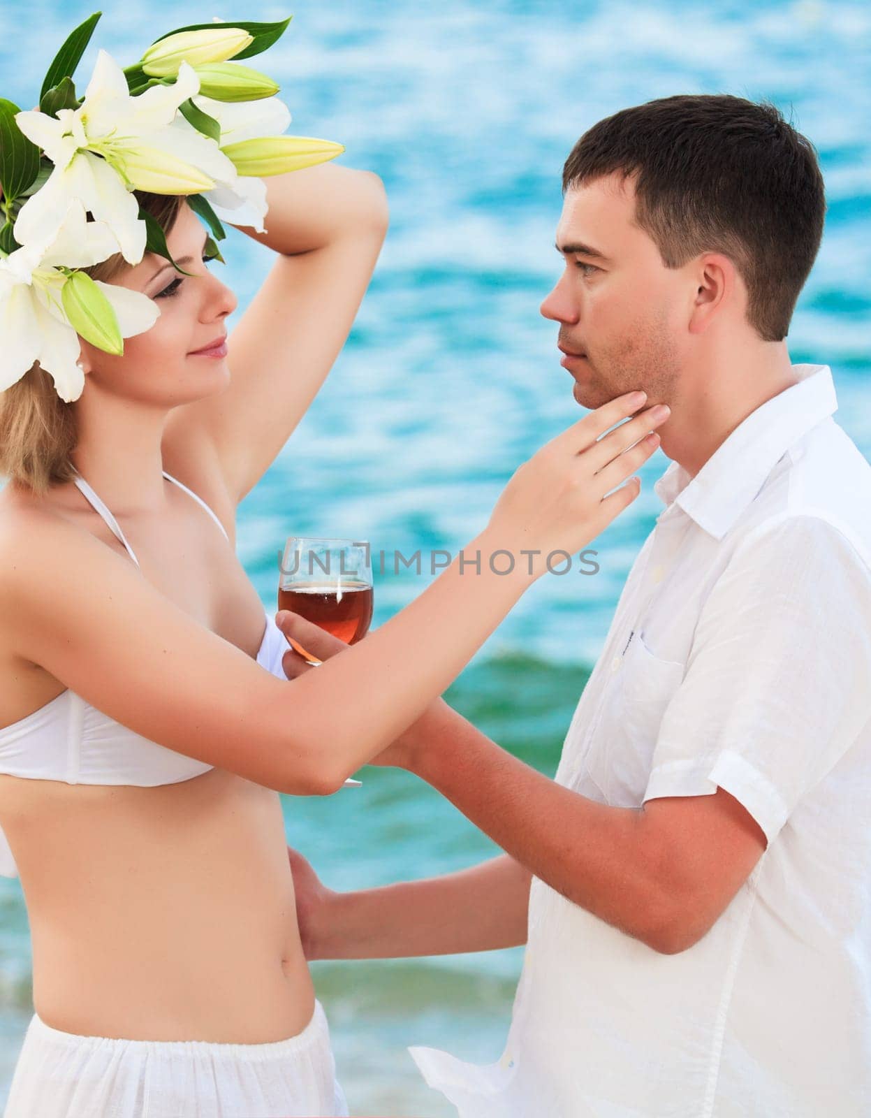 Romantic couple near the ocean with flowers