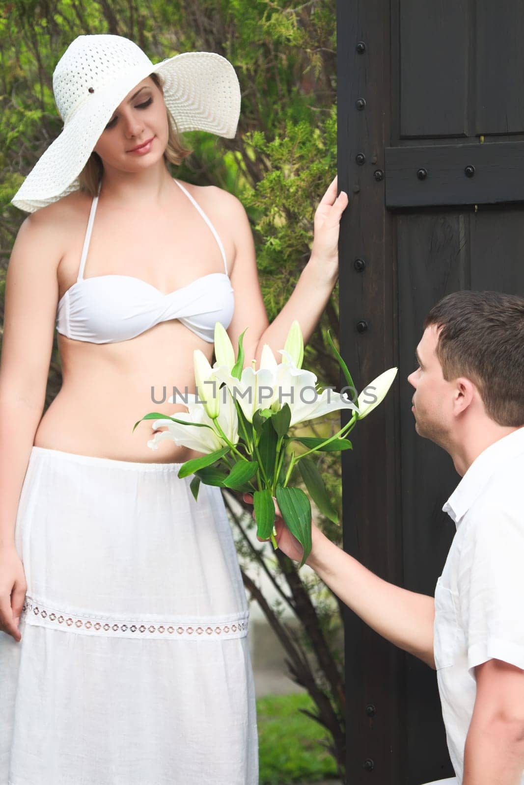 Man brings a bouquet of flowers woman