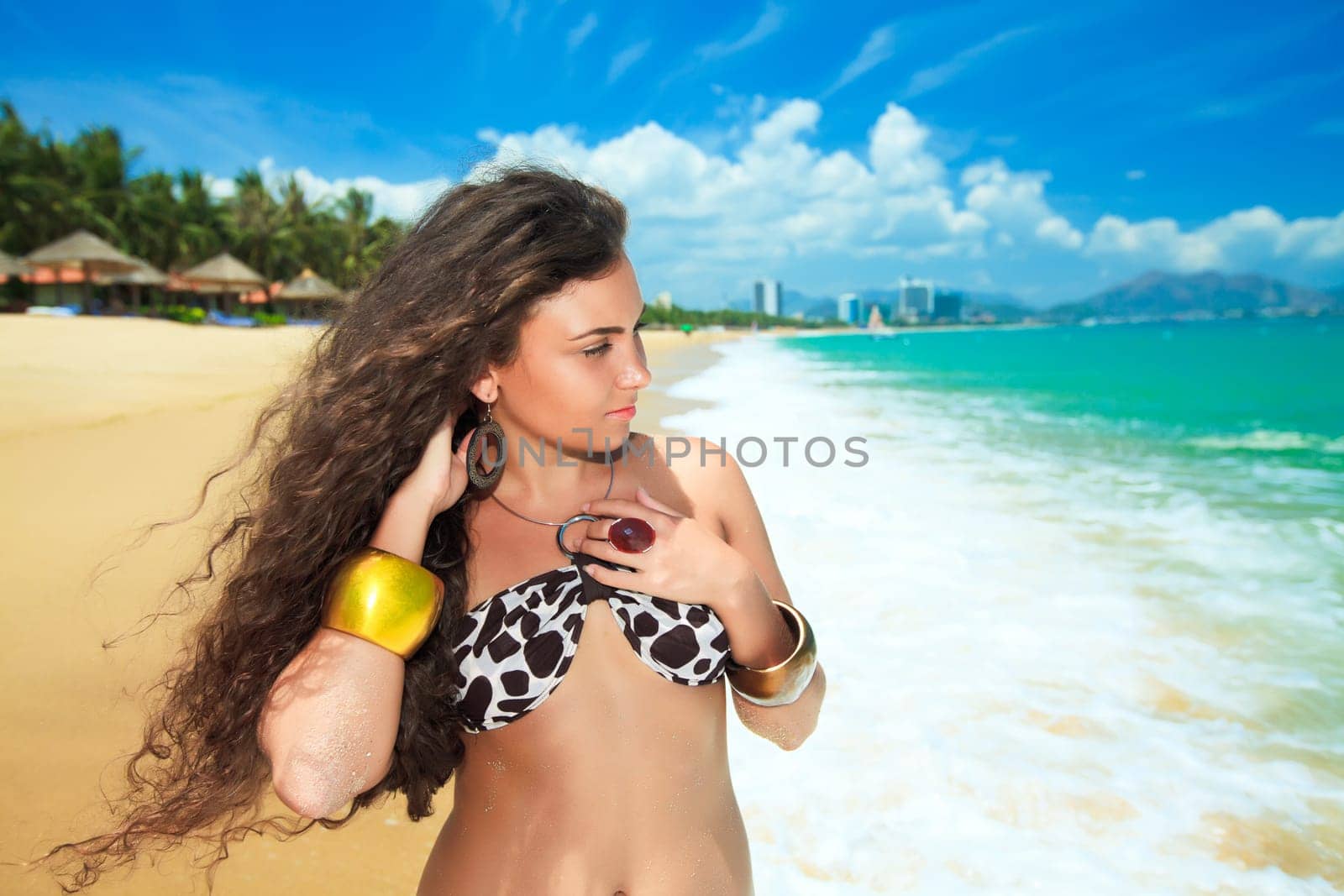 Young woman at the tropical beach near water