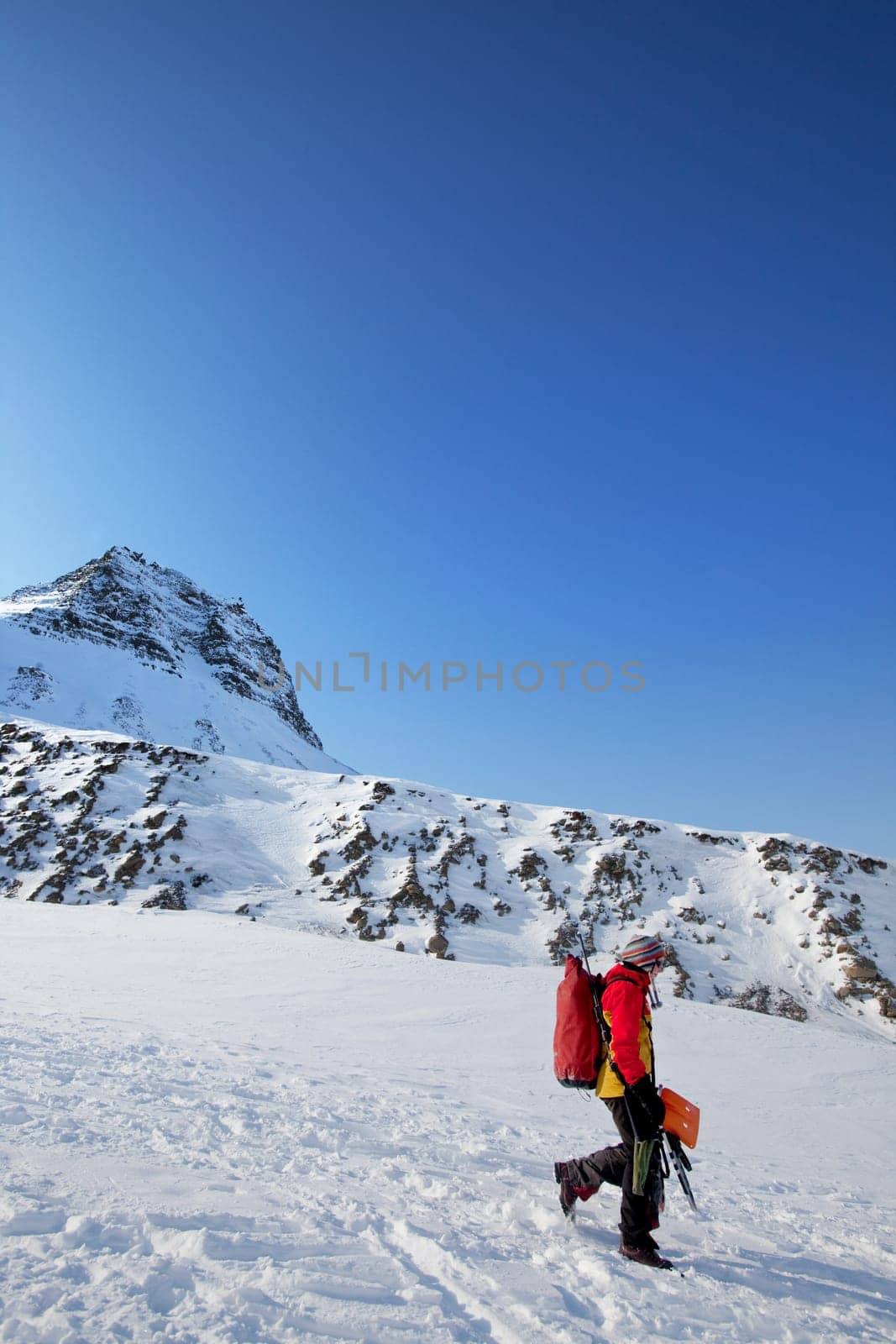 A female mountaineer against a mountain landscape, Svalbard, Norway