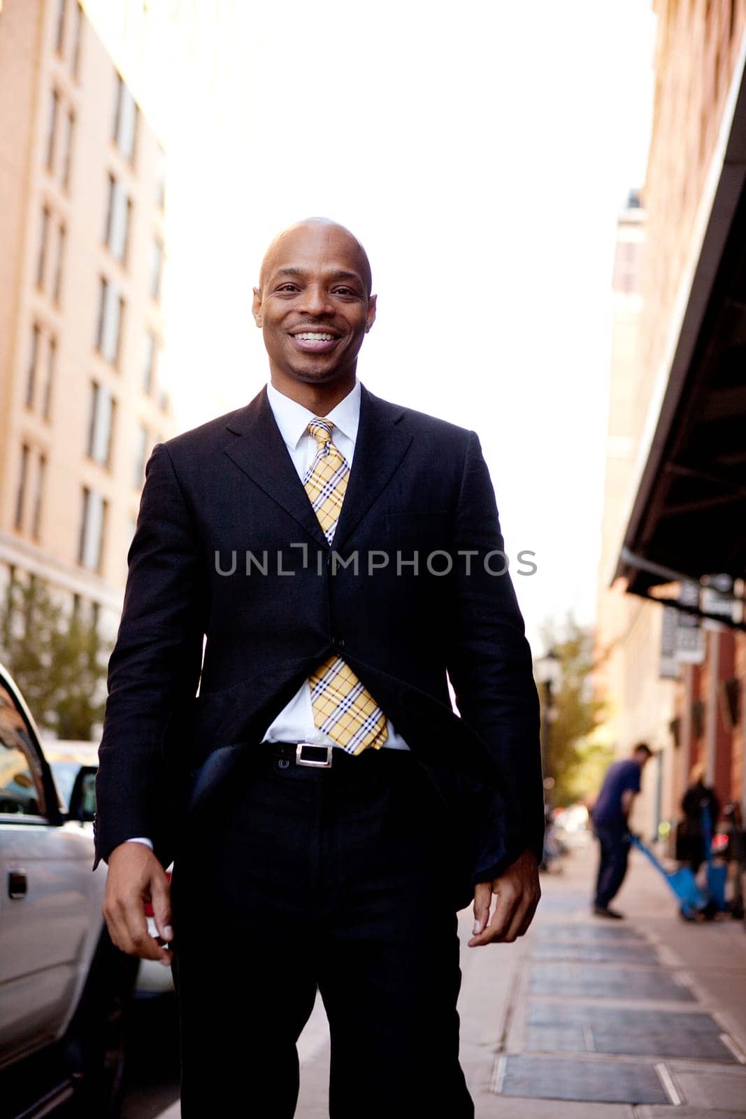 A street portrait of a business man walking on a sidewalk