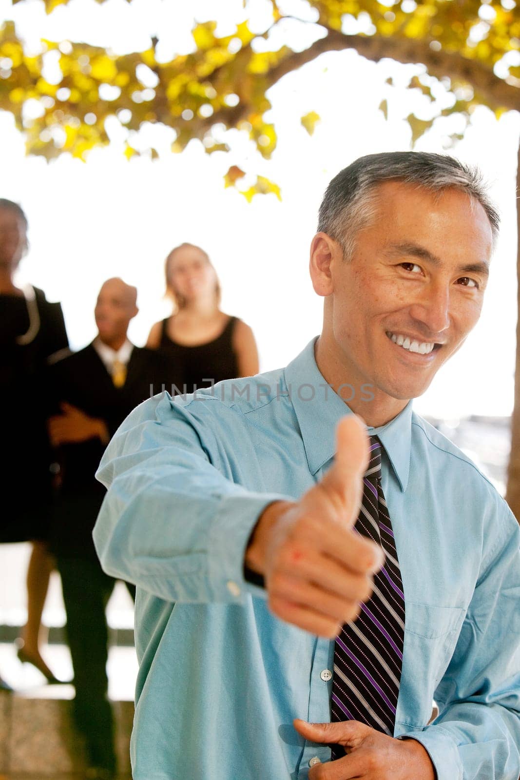 A casual business man with thumbs up