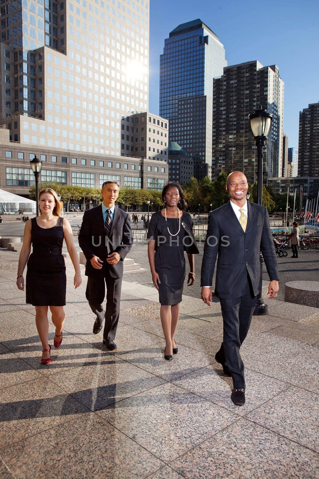 A group of business people walking down town in a large city
