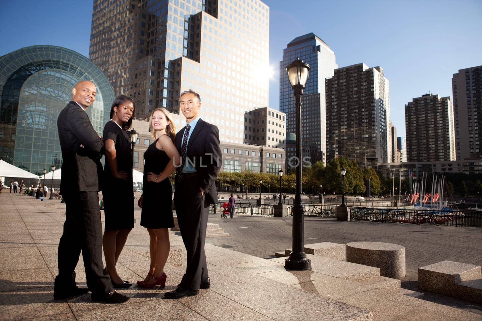 A successful business team in an outdoor setting against a city background