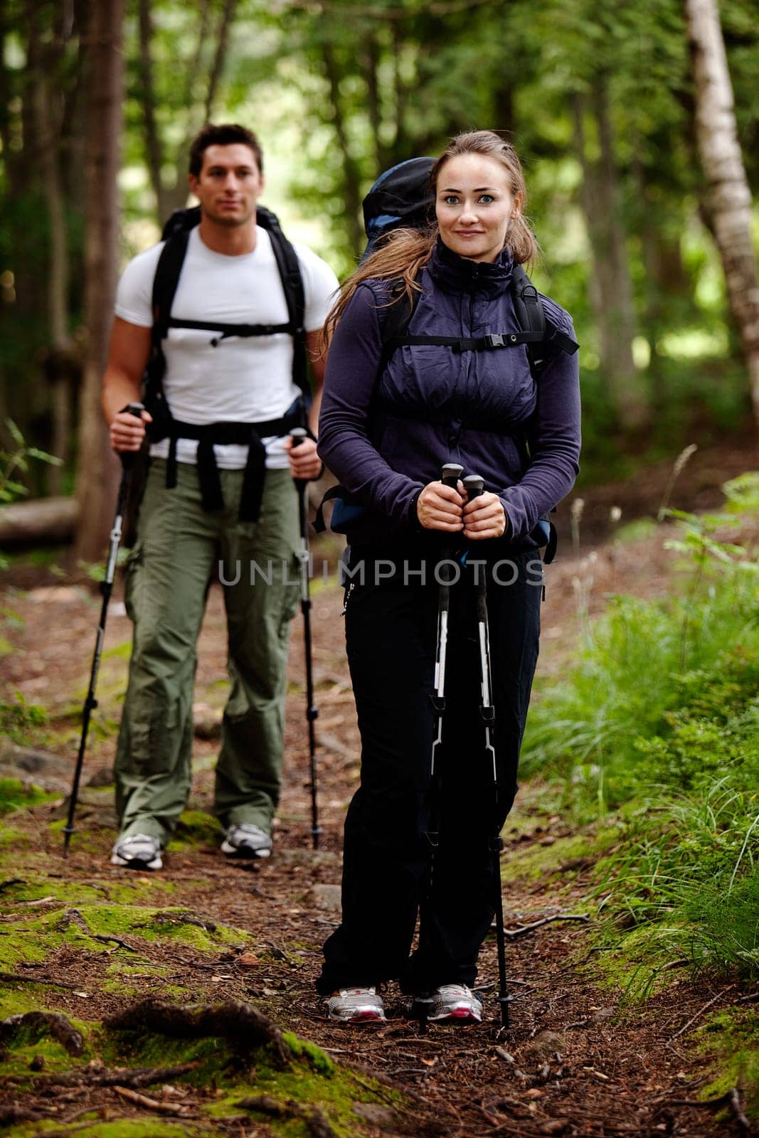 A pretty female on a camping trip with a male in the background