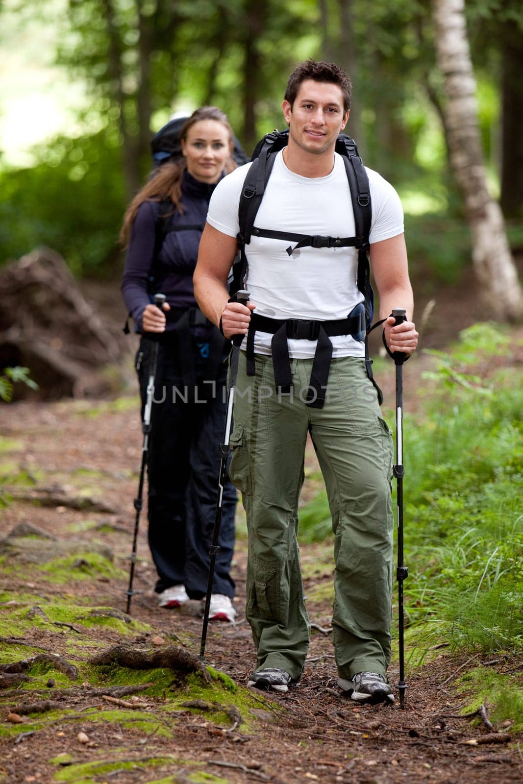 A man and woman on a camping trip in the forest.