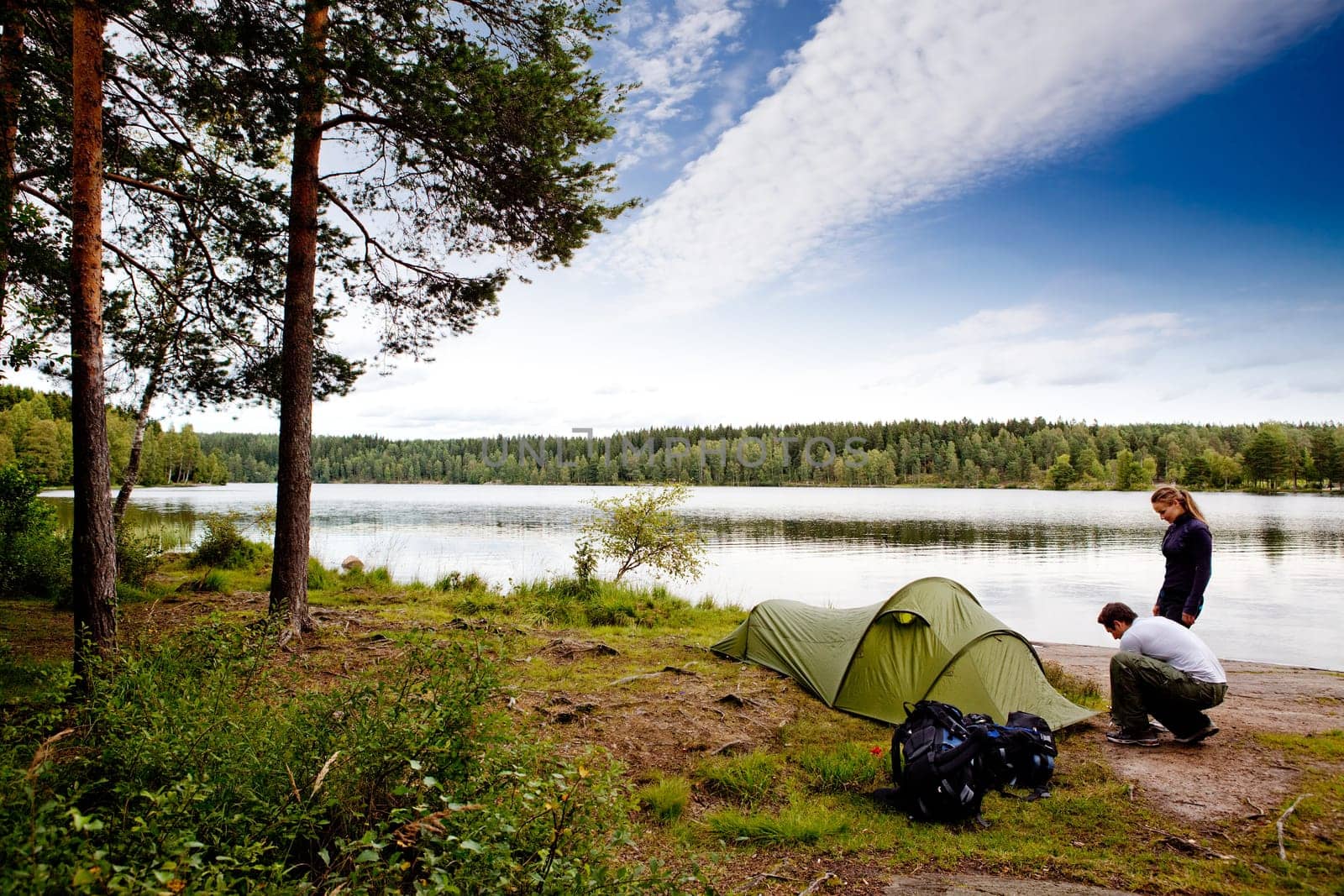 A couple camping on a lake landscape