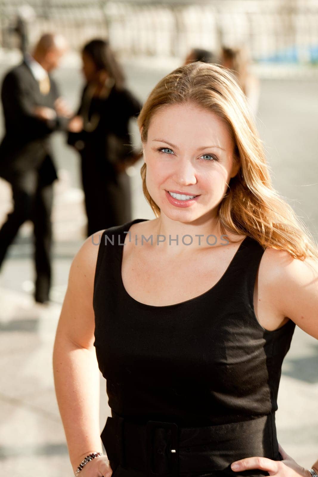 A business woman with coworkers in the background