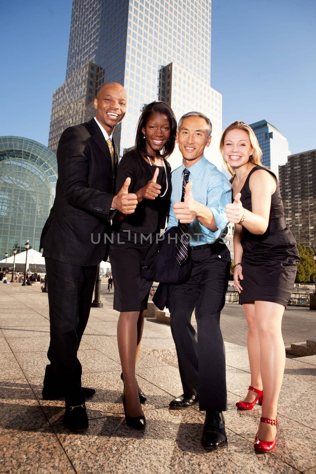 A group of business people giving a thumbs up sign