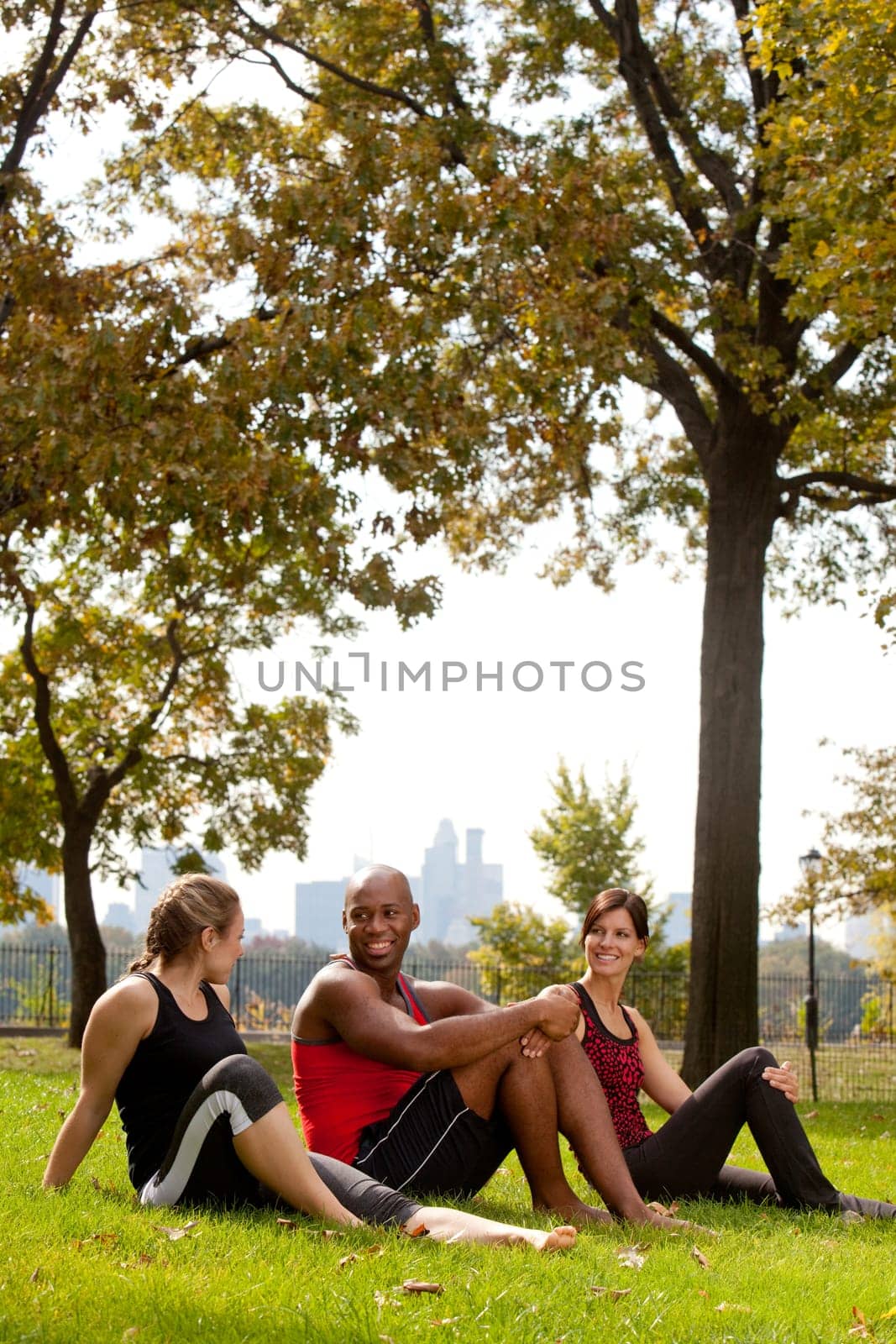 A group of people relaxing in the park after exercise