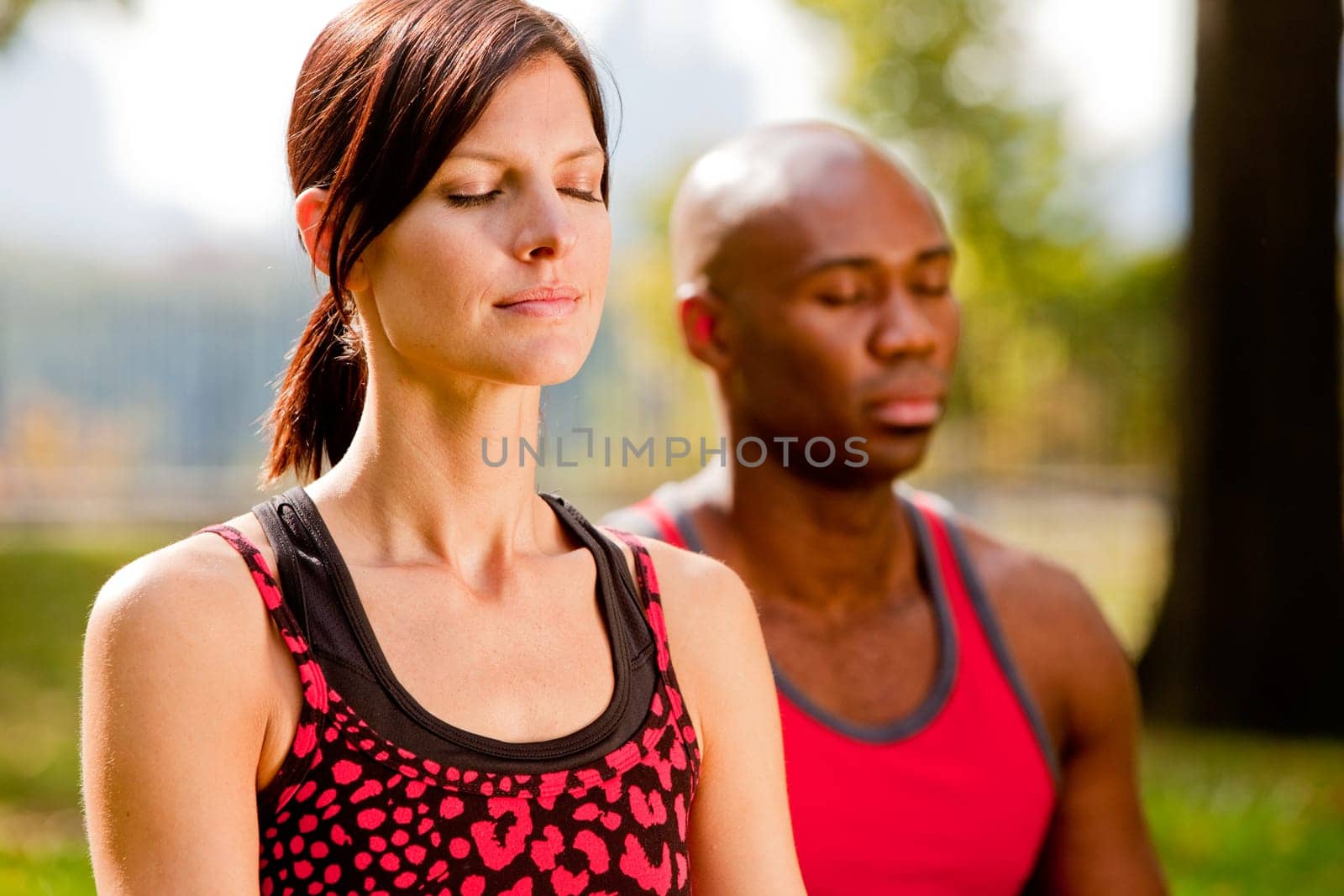 A group of people meditation in a city park