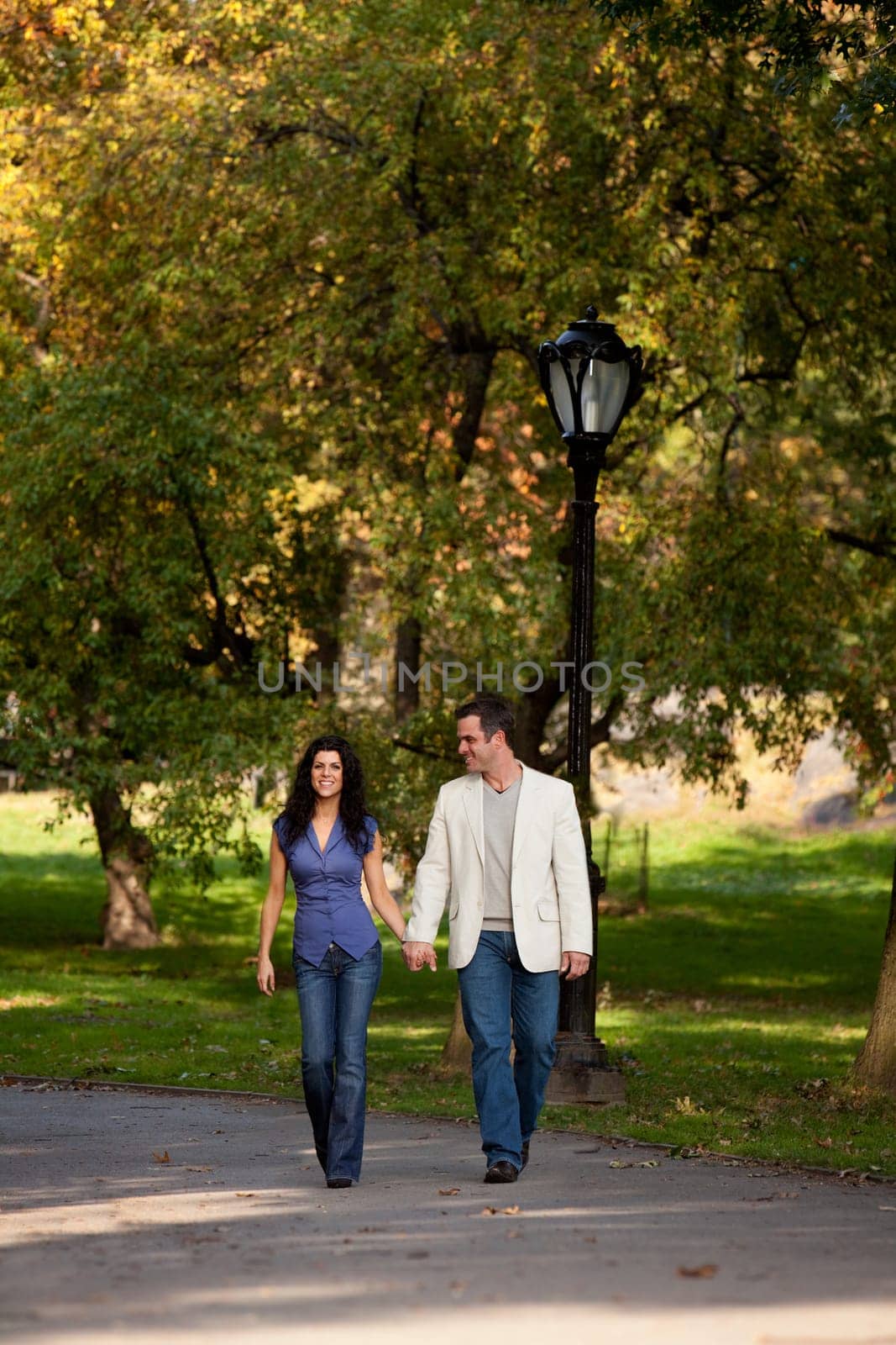 A happy couple walking in the park