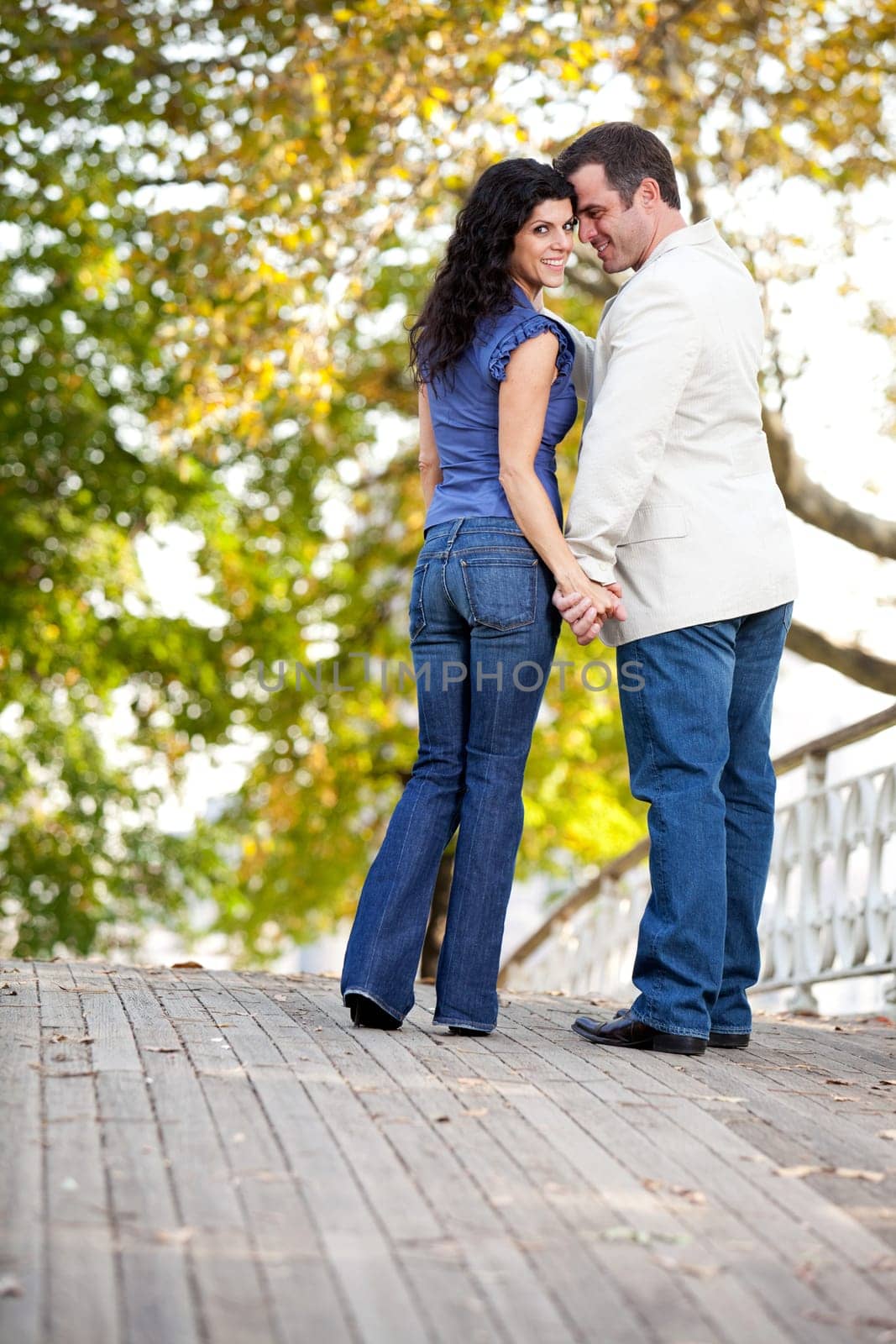 A happy couple in love walking on a bridge