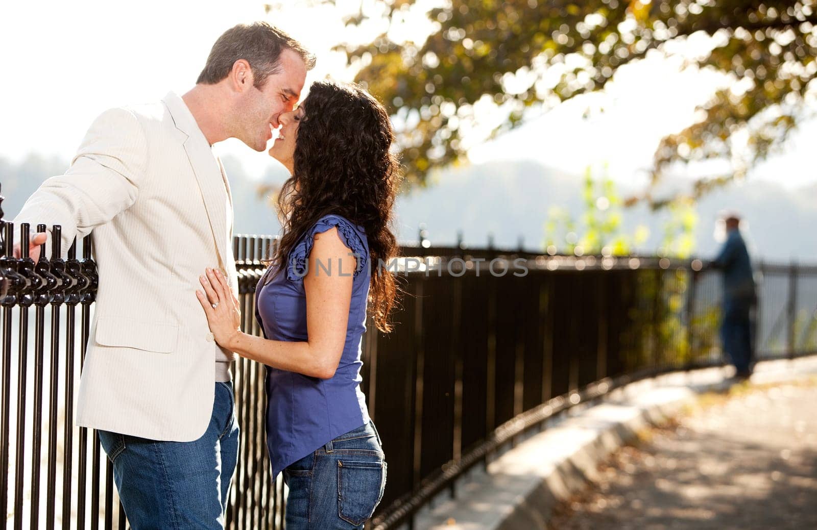 A happy couple in love kissing in the park