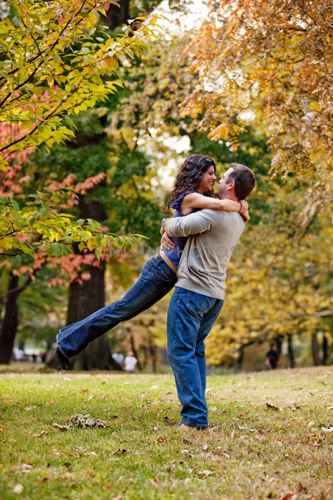 A man and woman hugging in a park