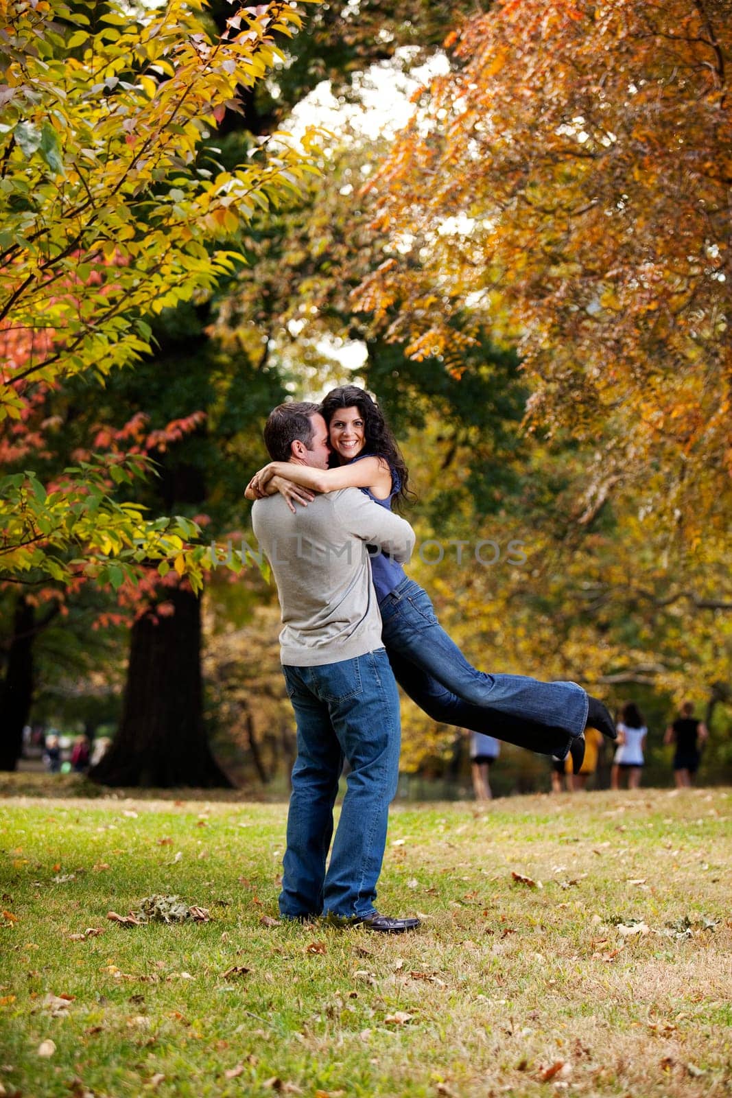 A man giving a bear hug to a woman