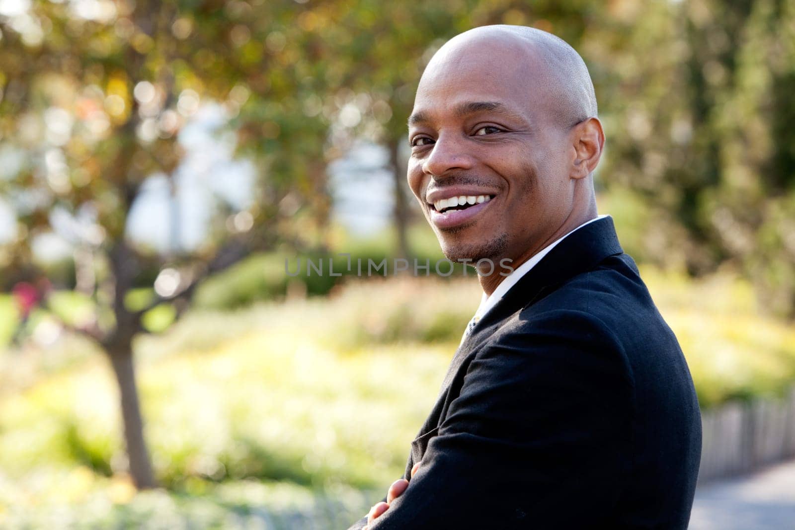 Mid adult male model in outdoor setting. Horizontally framed shot.