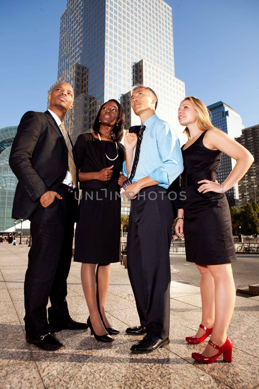 Four business people looking up. Horizontally framed shot.