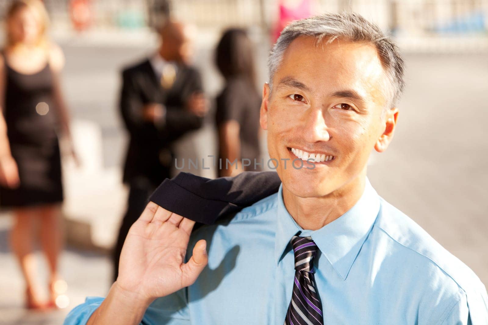 Four business people with middle aged man as focus. Horizontally framed shot.