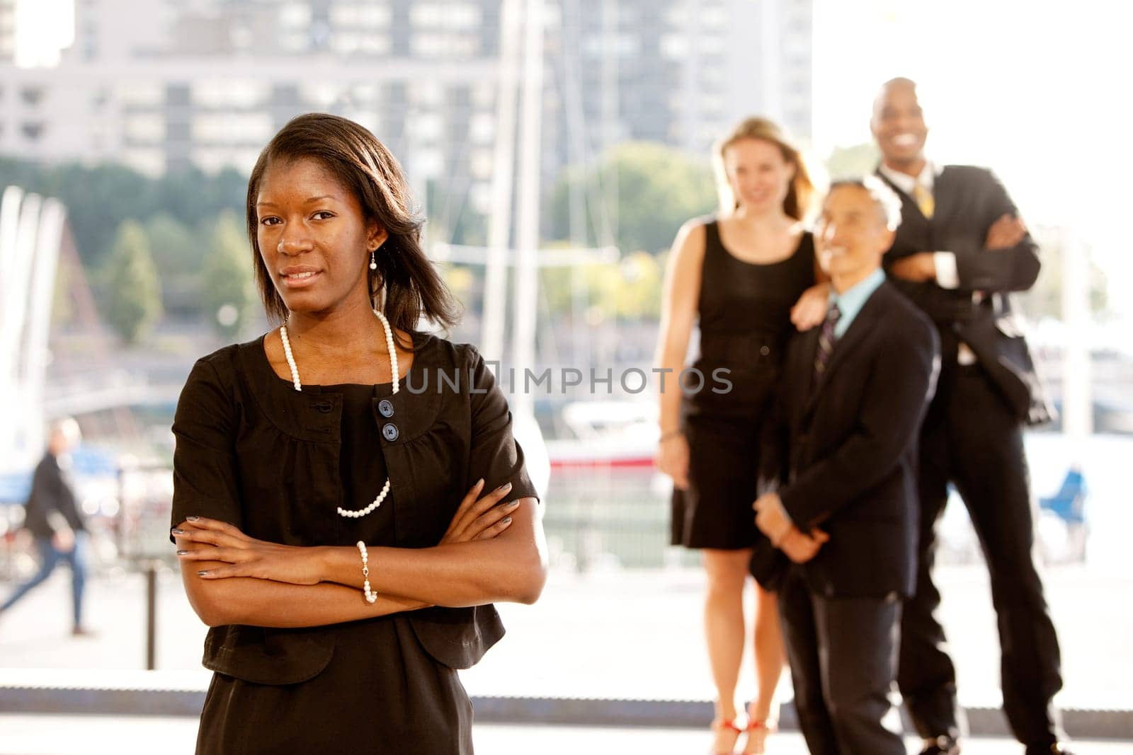 Group of four business people with one woman as focus. Horizontally framed shot.