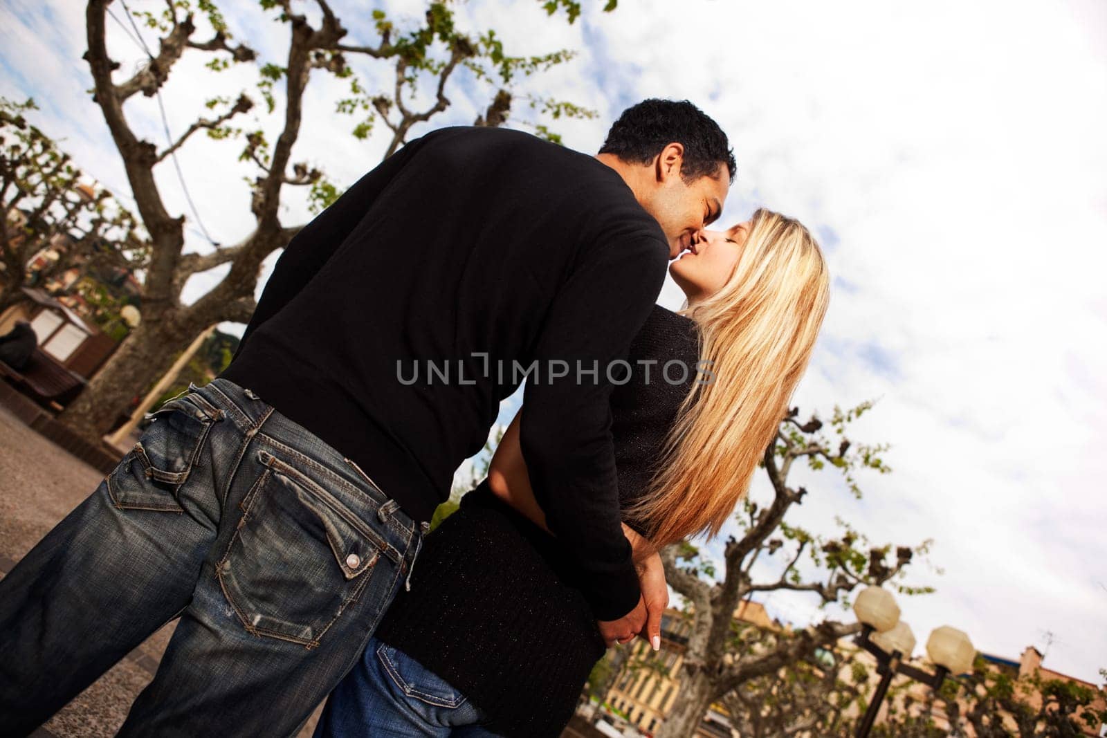 A couple kissing in a urban city park in France