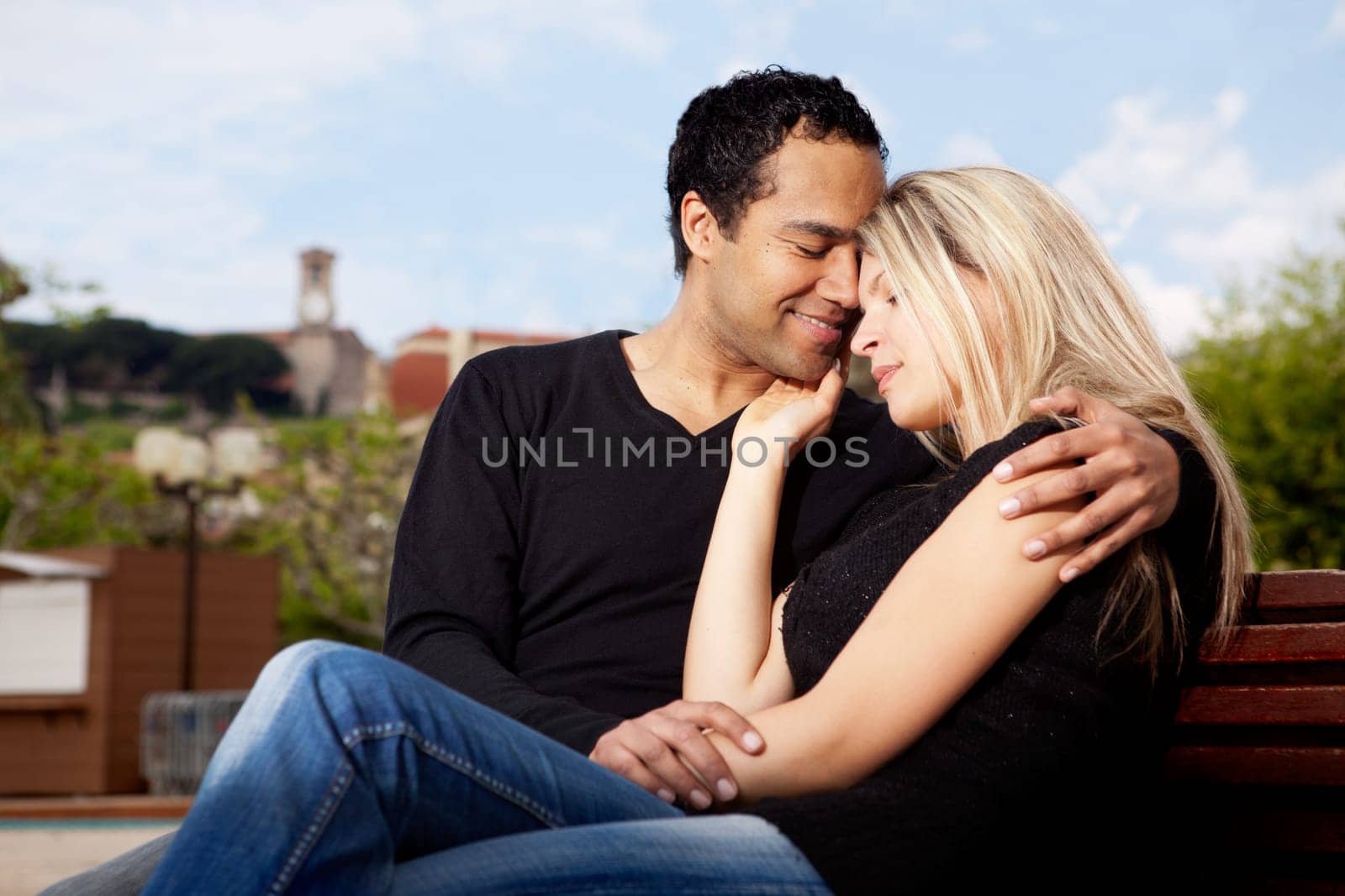 A happy french couple hugging in an urban park