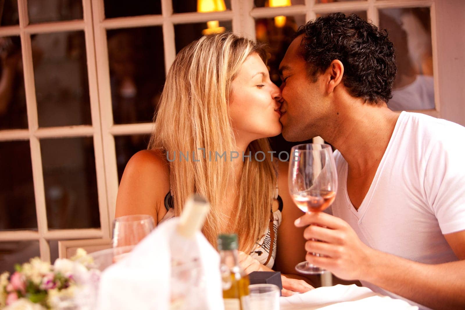A man and woman having a romantic meal in an outdoor cafe