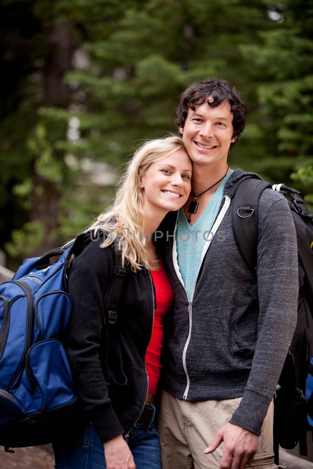 A young man and woman outdoors in the forest