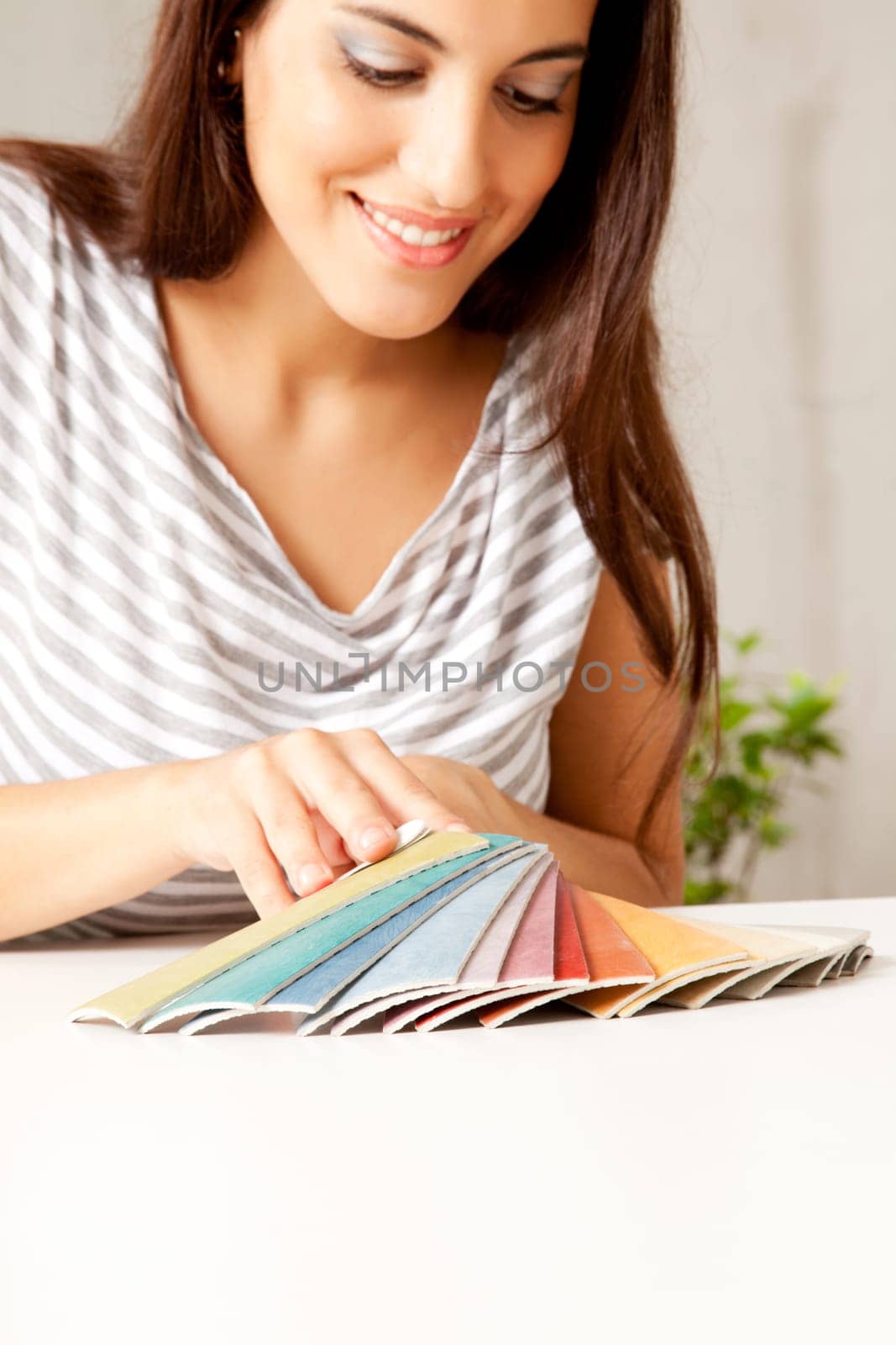 A woman looking at various flooring color swatches