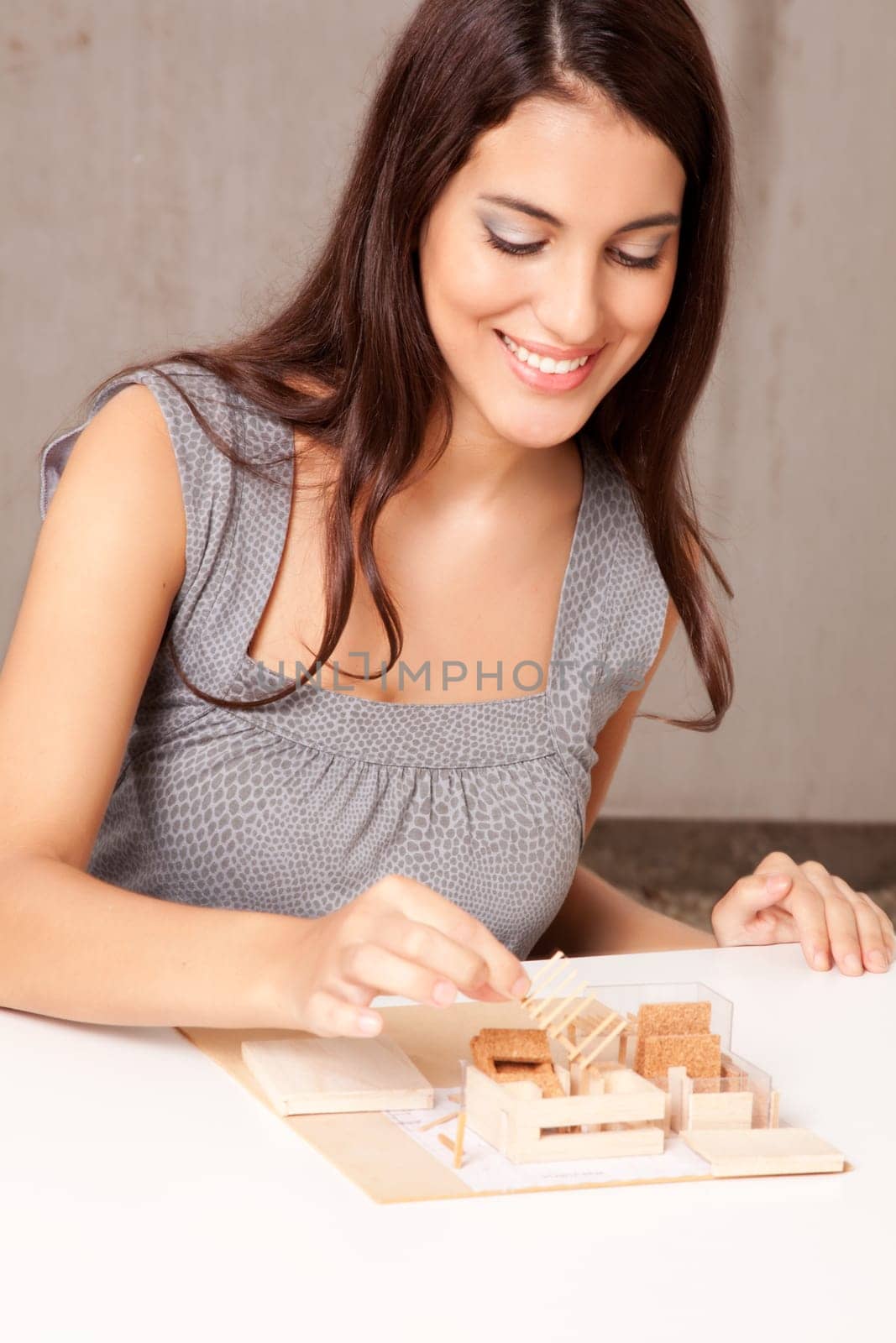 A female interior architect designign a scale model house