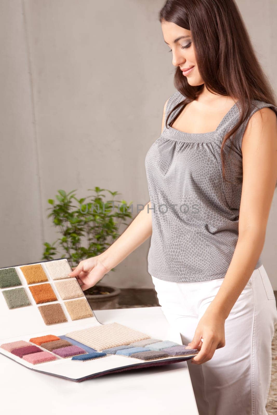 A female interior designer looking at carpet swatches in a catalogue