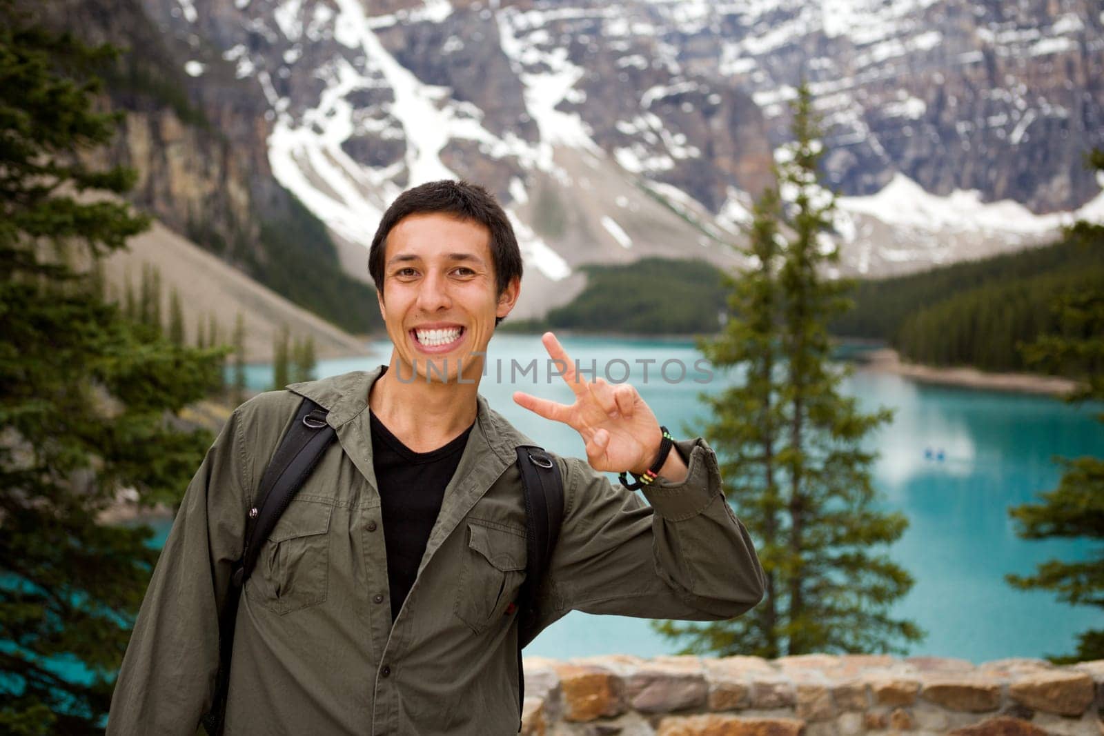 A portrait of a happy tourist in front of a scenic landscape