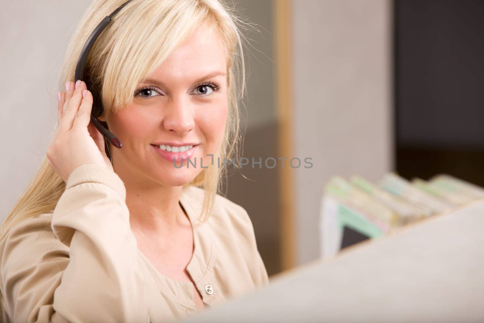 A happy receptionist with a phone headset
