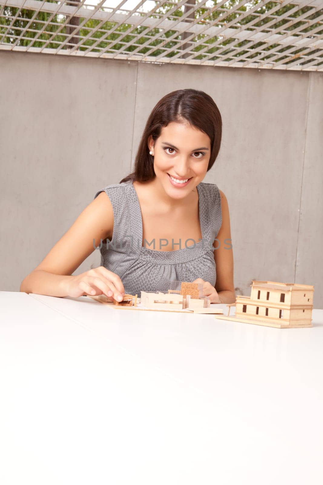 A female architect / designer working on a rough house model