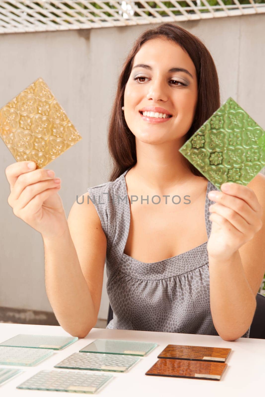 An interior architect / designer choosing a glass tile